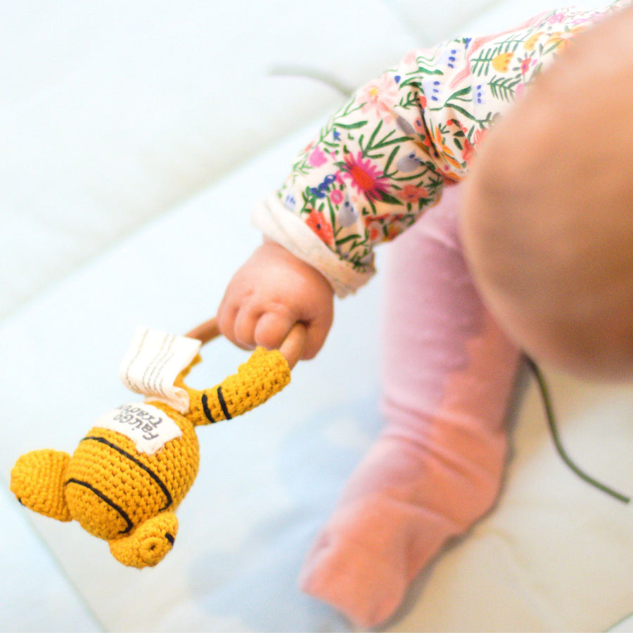 Baby playing with crochet play ring tiger