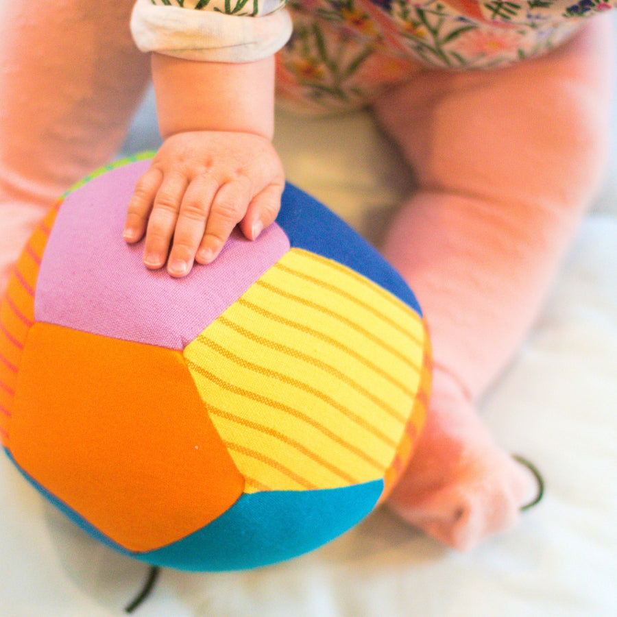 Baby playing with fair trade fabric ball