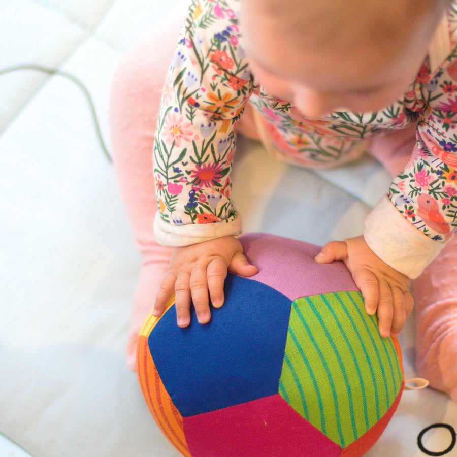 Baby playing with fair trade fabric ball