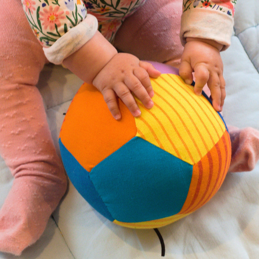 Baby playing with fair trade fabric ball